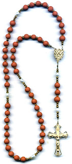 Brown color rosary beads in the Holy Rosary with with Jesus Christ on golden yellow cross pic
