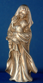 Mother Mary smiling golden statue with Child Jesus religious Christian photo