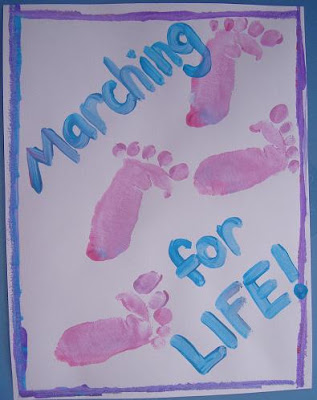 Pink foot print sign saying "Marching for Life!"