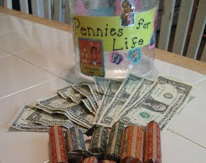 Jar with "Pennies for Life" next to US dollars and coins