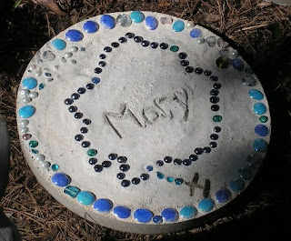 Stone circle with blue outline reading "Mary"