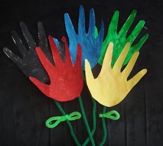 Painted paper handprints made into flowers on pipe cleaner stems