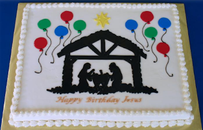 White cake with a nativity art and baloons reading "Happy Birthday Jesus"
