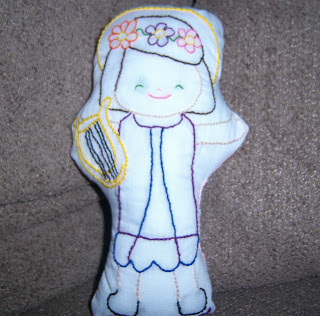 Embroidered doll of St. Cecilia