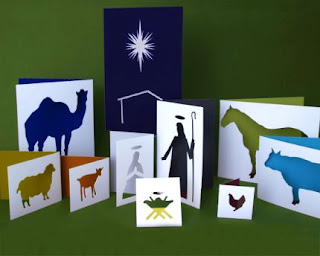 Paper card cutout of a nativity crèche.