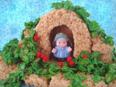 Finished Rice Krispie Mary grotto with Fisher Price Mary and green cornflake wreaths