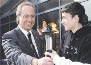 Mayor Randy Hope and Brett DeKoning, 16, a Grade 11 student at John McGregor Secondary School, help light the torch at the beginning of the Chatham-Kent portion of a Canada-wide campaign to raise awareness for organ and tissue donation