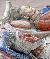 A color photo of the recumbent effigies or gisants of the tombs of Eleanor and Henry at the Abbey of Fontevraud.