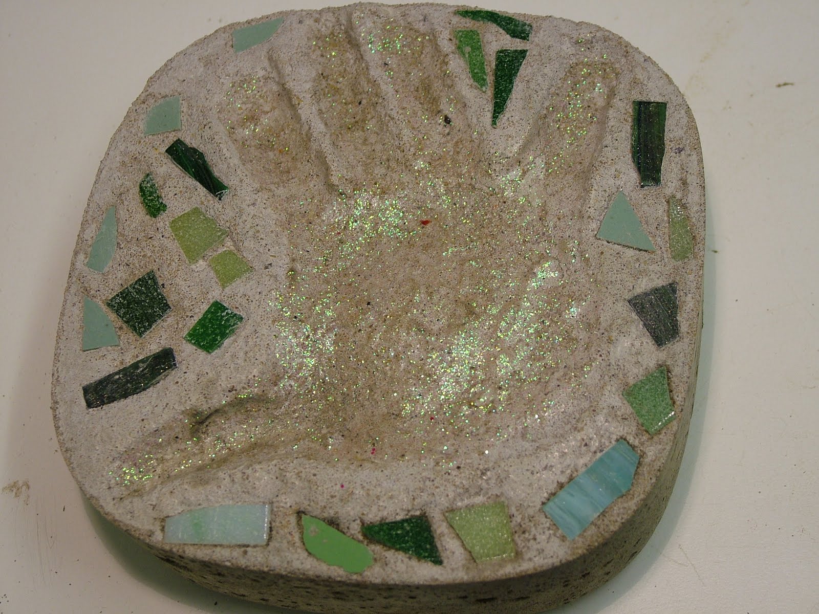 Glittering Shards Make mosaic cement foot prints and hand prints