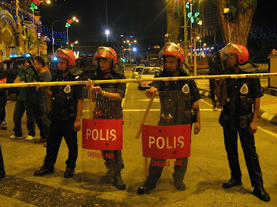potentially violent riot police with guns and batons plus shields potentially violent riot police with guns and batons plus shields