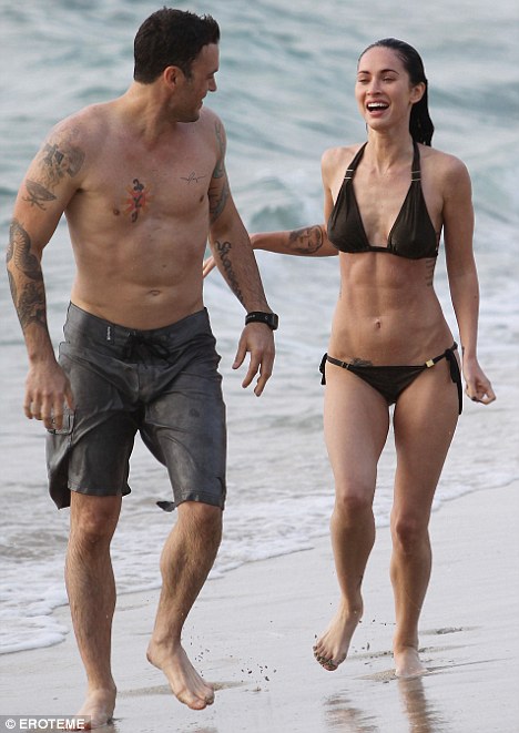 Toned torso: Megan Fox, seen with boyfriend Brian Green, put her impressive 