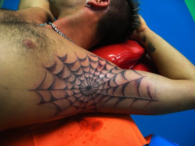 What is the significance of spider web tattoos on elbows?