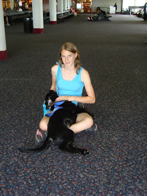 Picture of Rudy laying in my lap, you can see people waiting in seats behind us