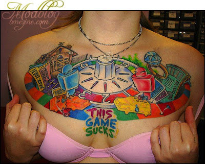 Game Tattoo Design on Sexy Girl Chest. 'This Game Sucks'