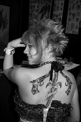 Tattooed Women Gun Tattoo and Dagger Tattoo on Back