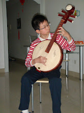 Uncle Nelson's son Tom playing traditional Chinese Instrument