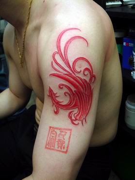 Tribal type red phoenix tattoo on the arm