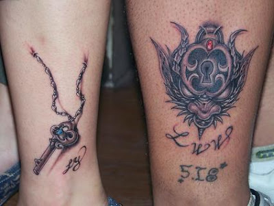 Matching lock and key tattoos on the leg