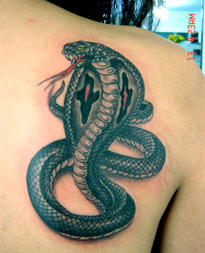 Cobra tattoo below the shoulder