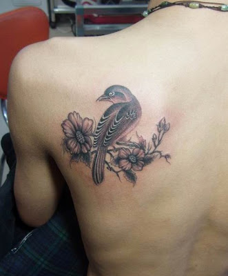 bird and flower tattoo design on the shoulder