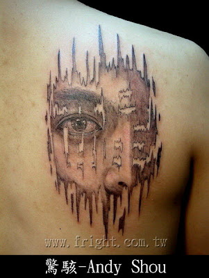 Fading portrait tattoo on the back 