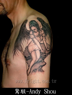 An arm tattoo showing an angel resting on a rock