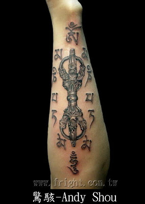 Sanskrit and scepter tattoo on the arm