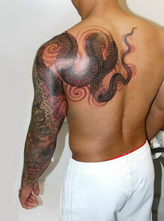 python tattoo design on the arm