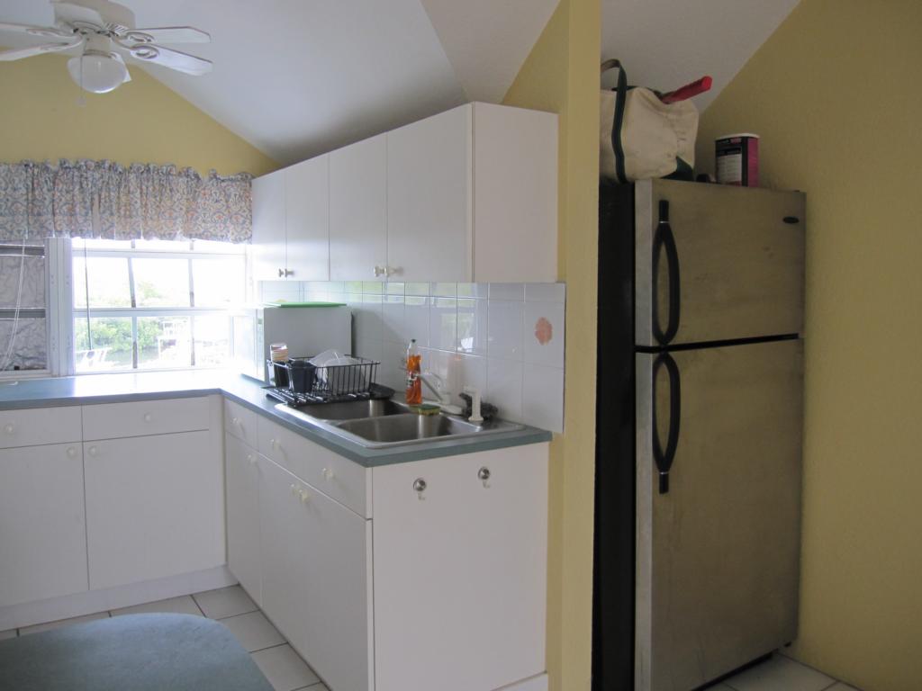 REAL ESTATE TIPS: KITCHEN AREA with White Formica Cabinets ...