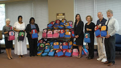 Haddaway-Riccio distributes backpacks to local children