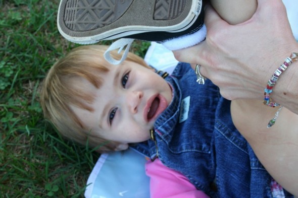 Lilli getting her diaper changed in the middle of the field