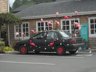 Black Art Car with Flamingos on poles Black Art Car with Flamingos on poles