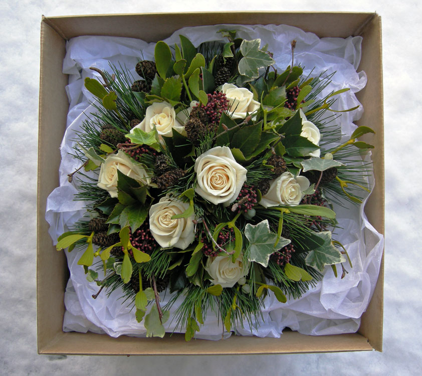 Winter wedding bouquet with a strong Christmas look of roses holly ivy Winter wedding bouquet with a strong Christmas look of roses holly ivy