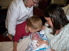 Ethan saying hi to Evan with Mom and Grandmom looking on