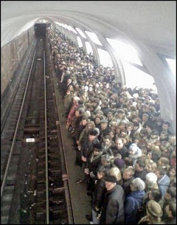 funny photo of packed subway train platform station very dangerous