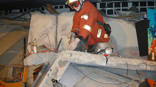 model of fireman cutting through debris