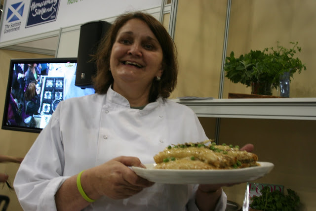 Valentina shows off Allegra's dish, trout pancakes