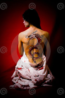 YOUNG WOMAN WITH DRAGON TATTOO