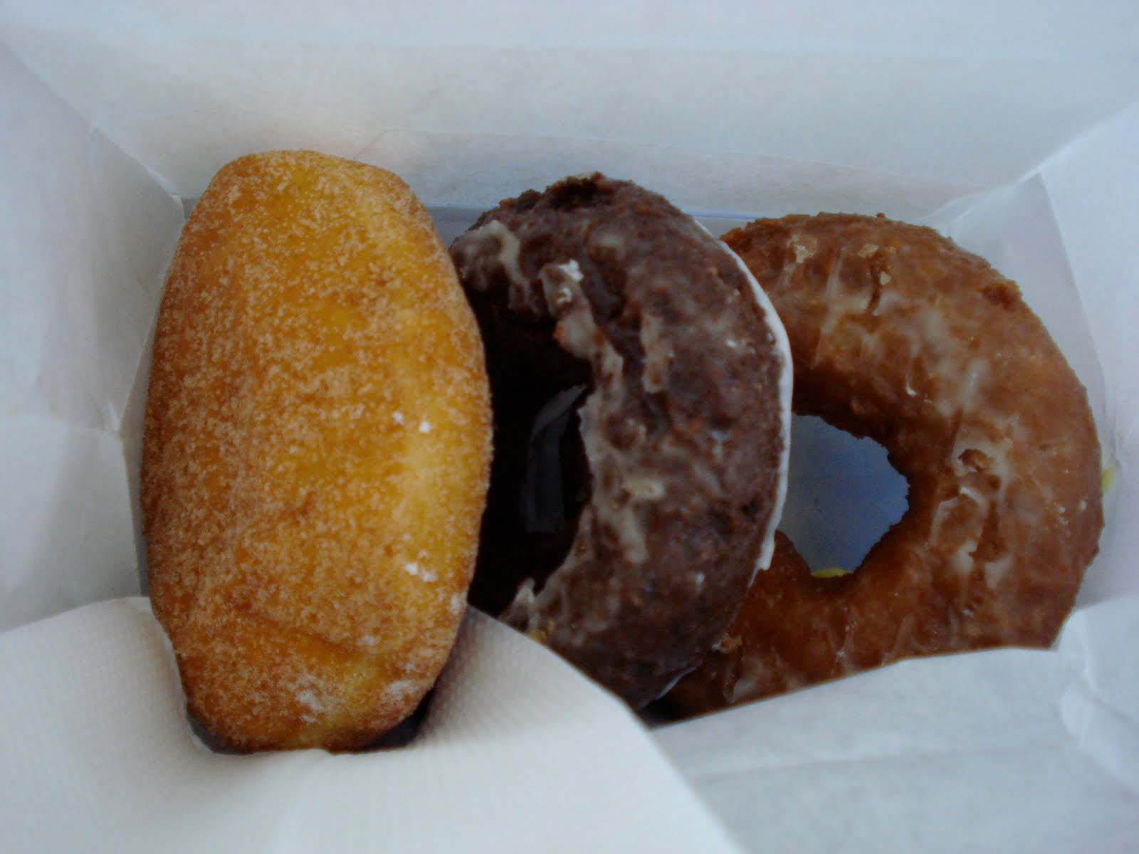 Penguin Eats Baker's Dozen Donuts Topeka, Kansas