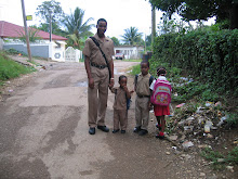 A common site, big brother taking the siblings to school