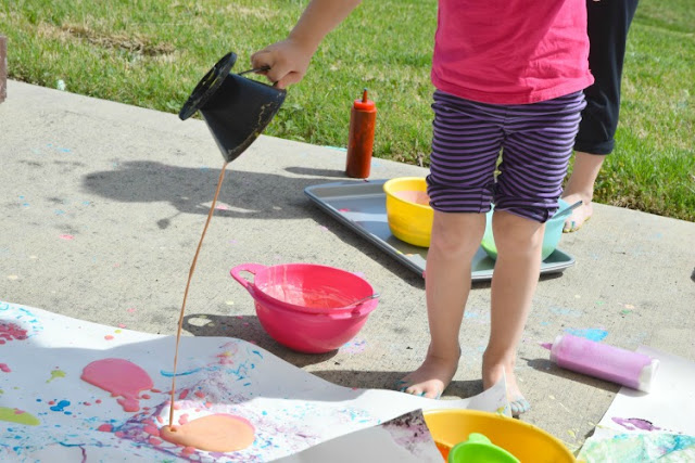 Squirt! Drip! Pour! Process Art Painting For Kids.  Head outside for some messy painting fun for spring our summer.  Preschoolers, kindergartners, and elementary students will LOVE this opportunity to make giant process art.