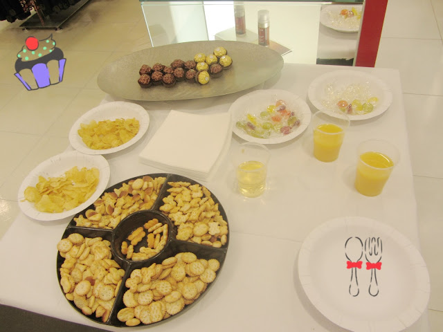 A table full of nibble food and orange juice 