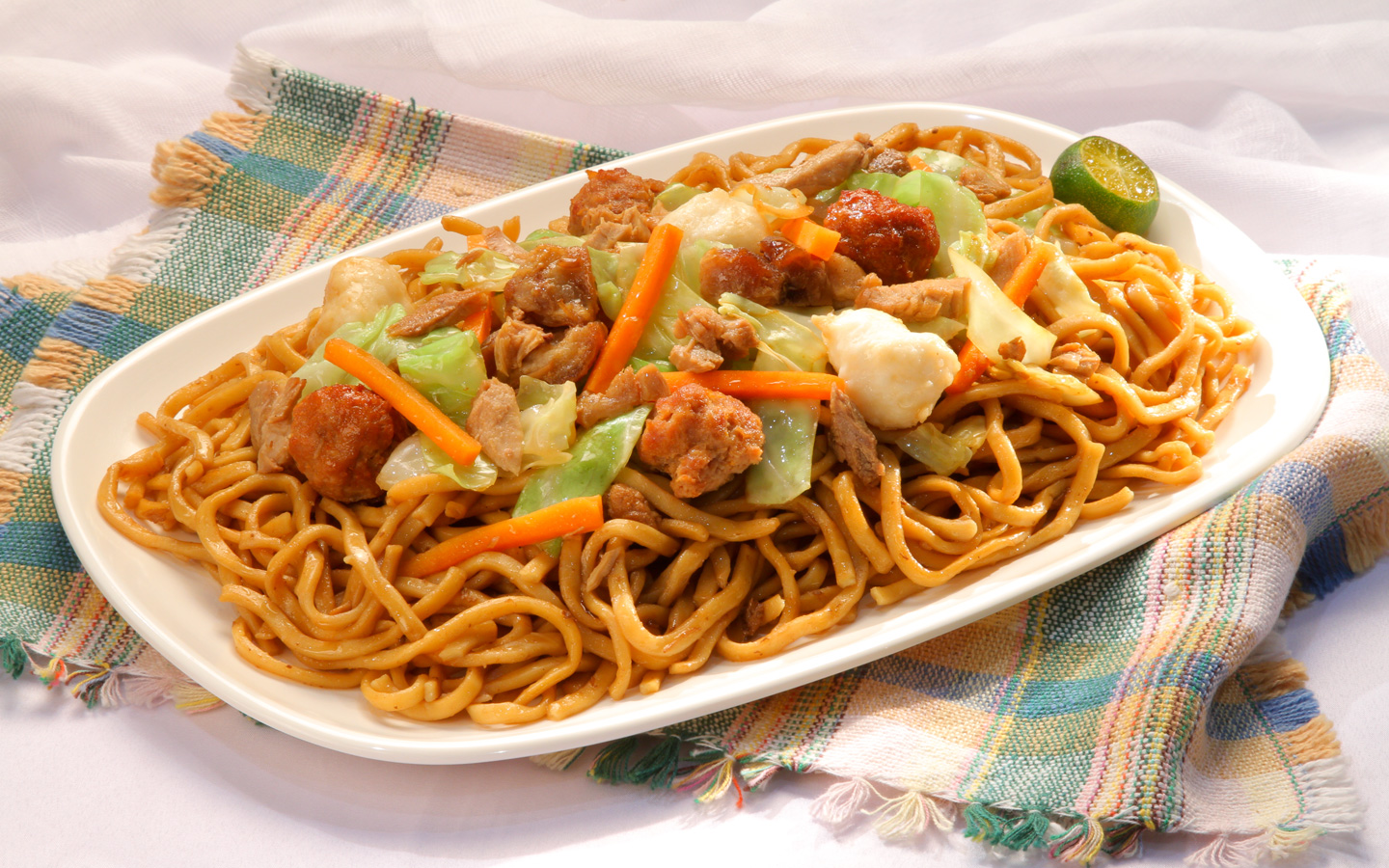 One reason why Filipinos put pancit or sometimes spaghetti on the dining ta...