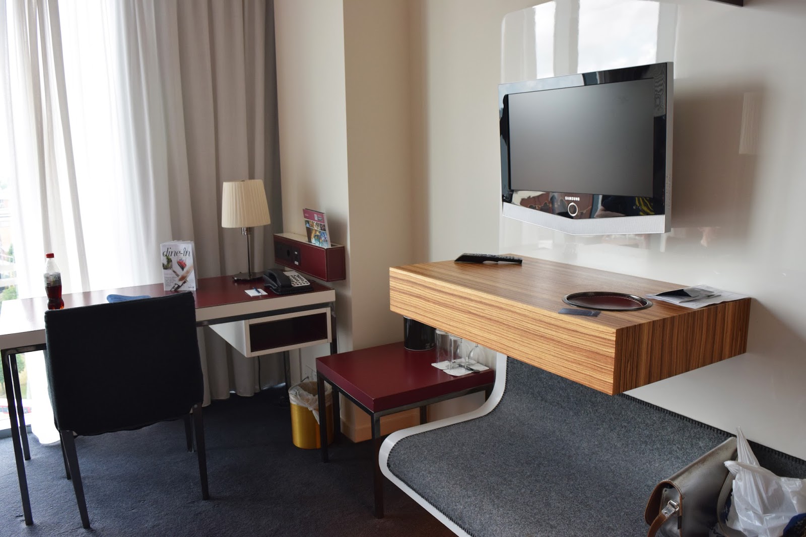 another view of the hotel room, focusing on the desk area and wall mounted tv