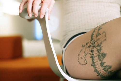 Gun Tattoo on Girl Thigh