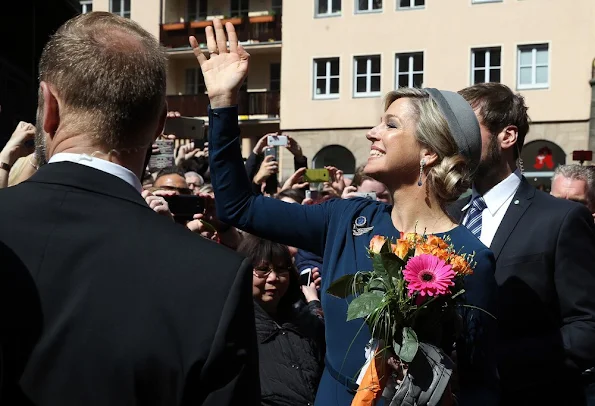 King Willem-Alexander and Queen Maxima of the Netherlands cross the Townhall square