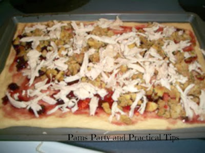 Adding more ingredients to leftover turkey pizza 