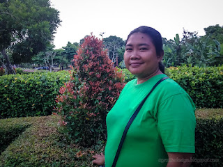 Woman Smile Enjoy A Holiday In The Garden Plants Of The Parking Lot At Badung, Bali, Indonesia
