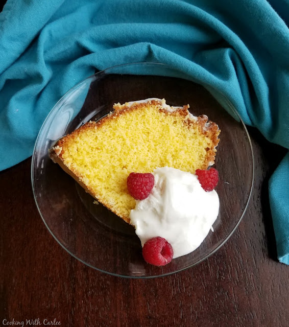 A delicious cake that is made not with butter, but egg yolks! It is a light and simple to make cake and a great way to use yolks left from meringues or angel food cakes. slice of gold cake on glass plate with whipped cream and raspberries