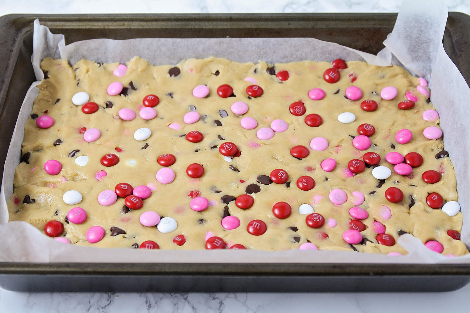 These adorable Valentine cookie bars are loaded with chocolate chips and M&M's. They're the perfect treat for your sweetheart!